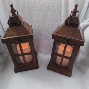 Wooden hanging lanterns with flickering flame light